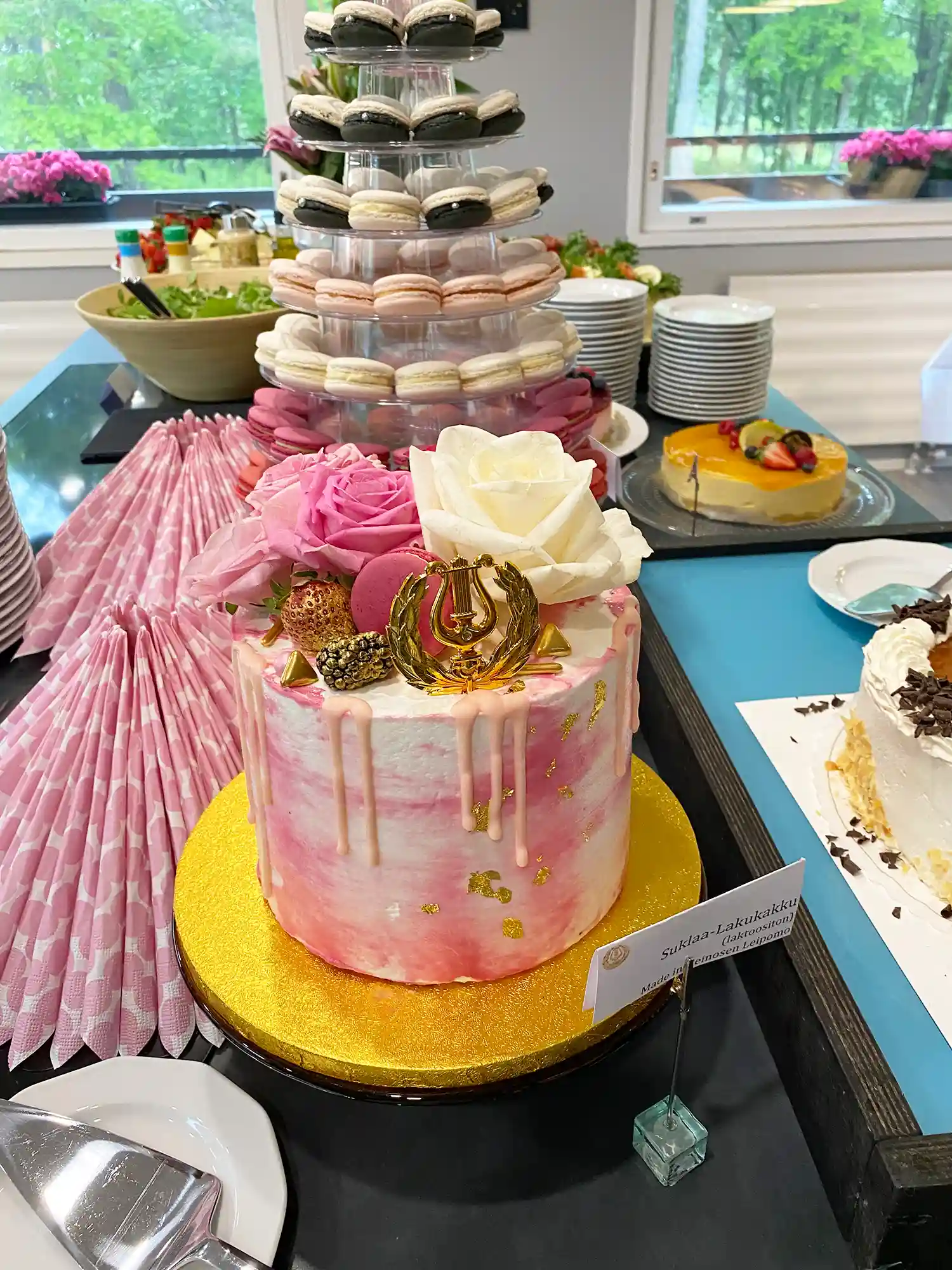 Ylioppilasjuhlien täytekakku ja macaronleivokset pöydällä